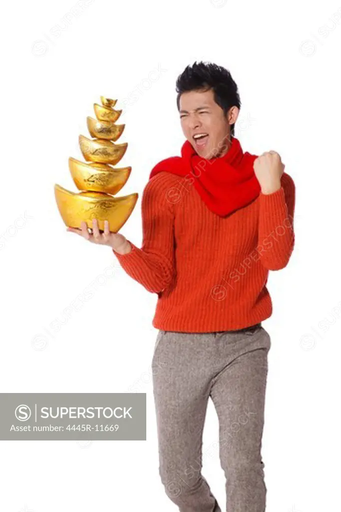 Young man holding gold ingots