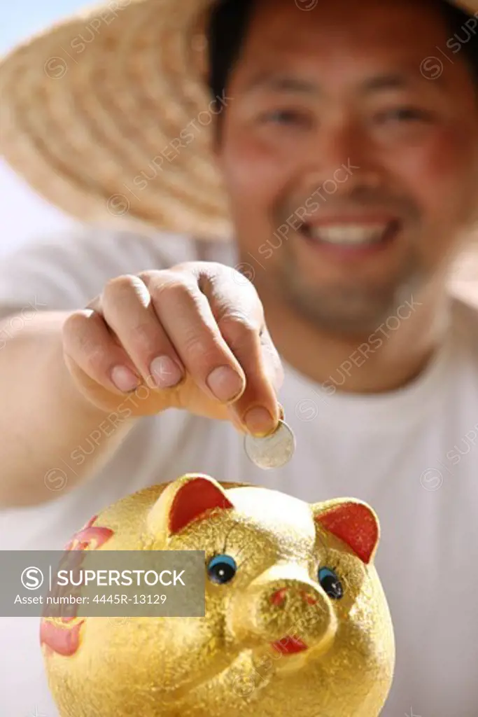 Farmer putting coin in piggy bank