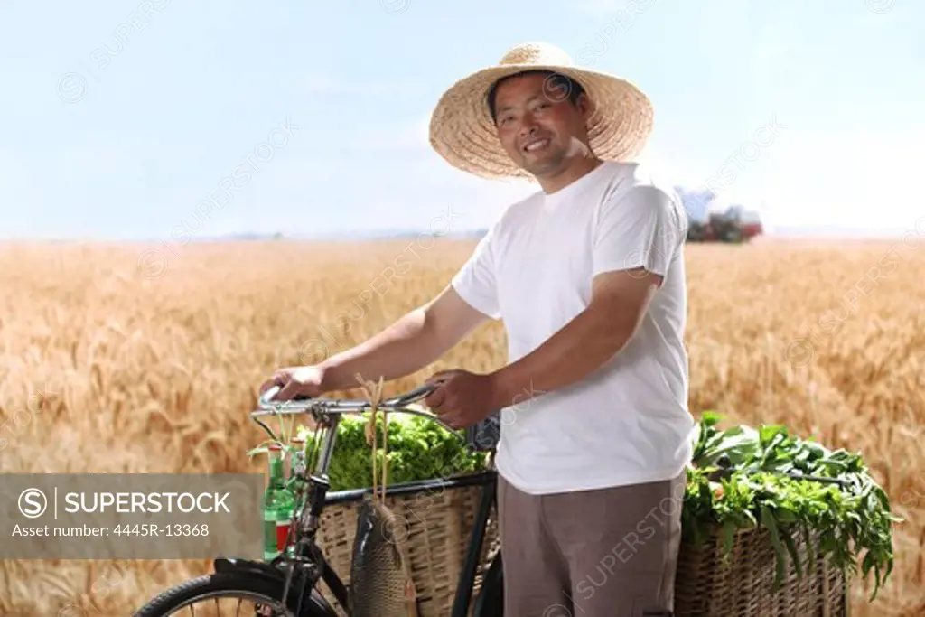 Farmer walking bike with vegetable