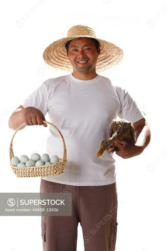 Farmer holding duck's eggs and duck