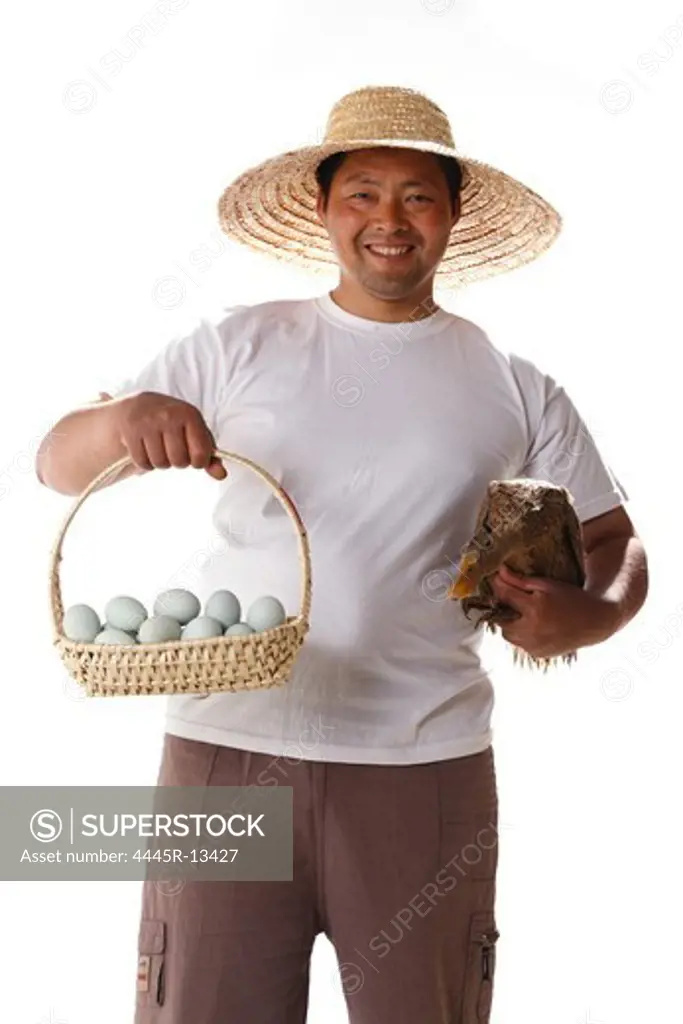 Farmer holding duck's eggs and duck