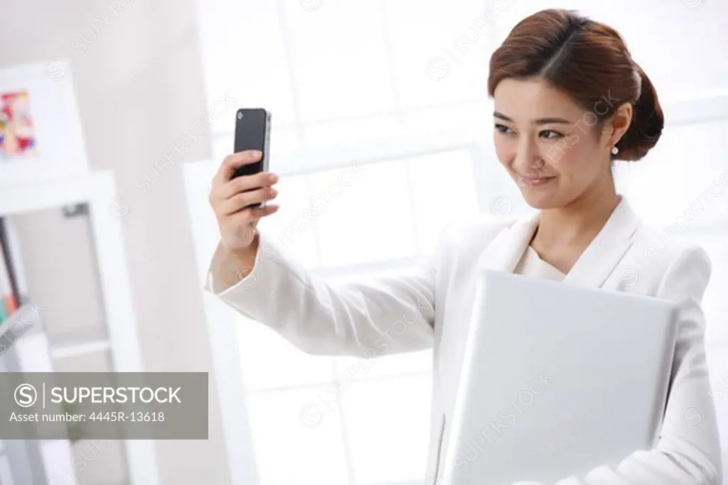 Young business lady using cellphone