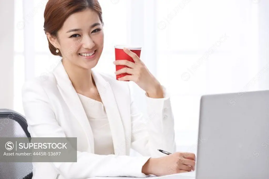 Young business lady drinking coffee