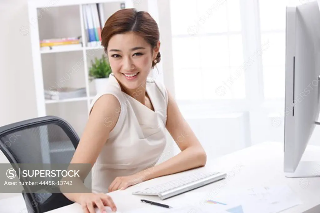 Young business lady sitting in front of computer