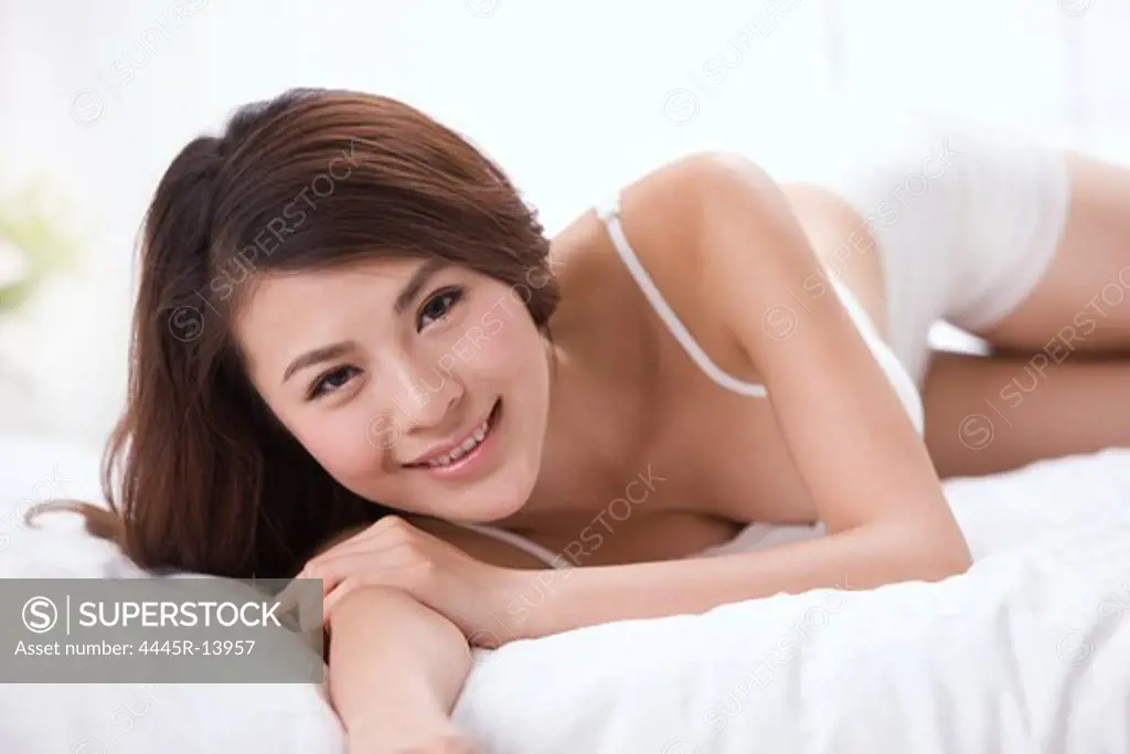 Young lady lying prone on bed