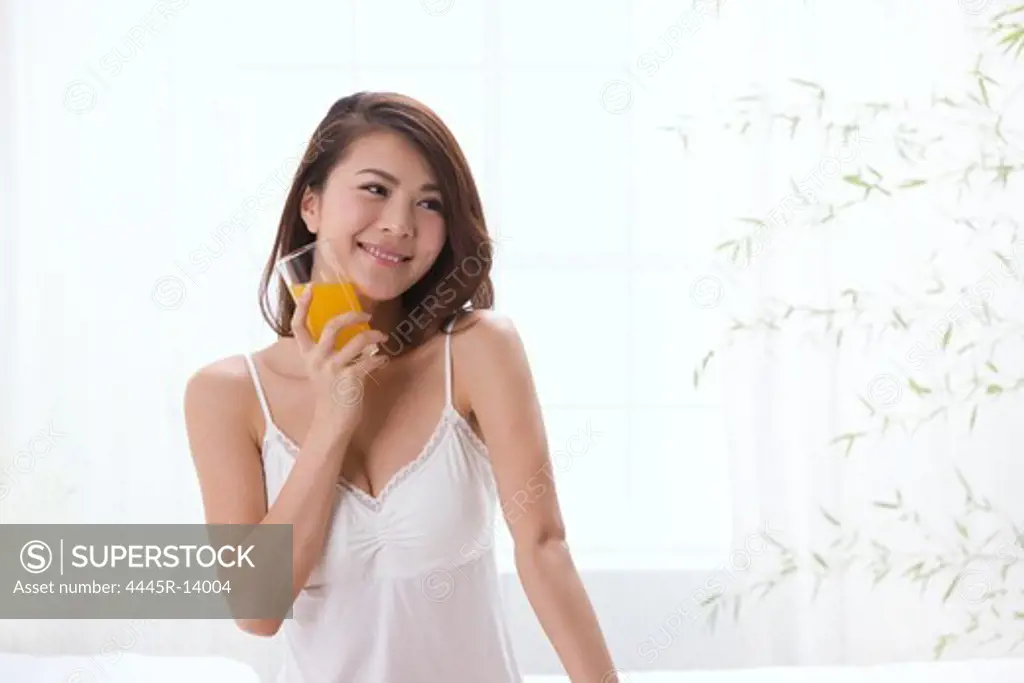 Young lady holding glass of juice