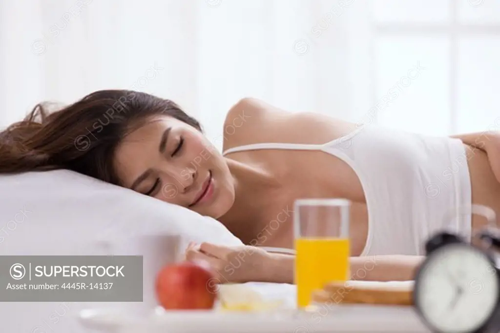 Young lady sleeping on bed