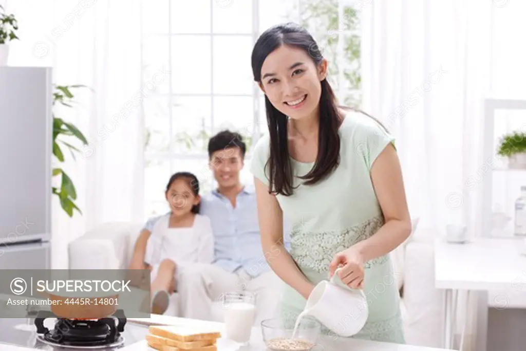 Family cooking breakfast in kitchen