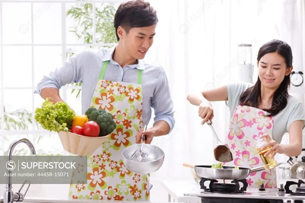 Young couple cooking in kitchen