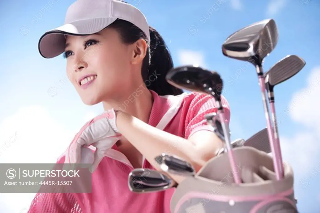 Young woman and golf clubs