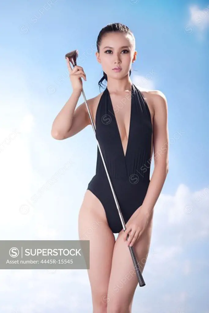 Sexy woman holding golf clubs