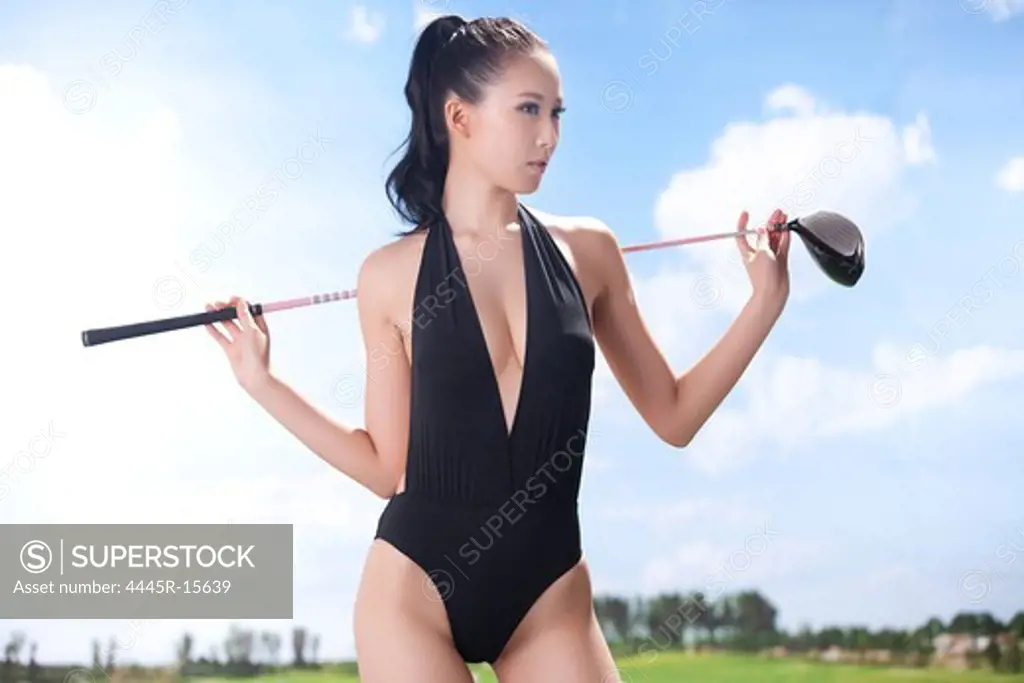 Sexy woman holding golf clubs