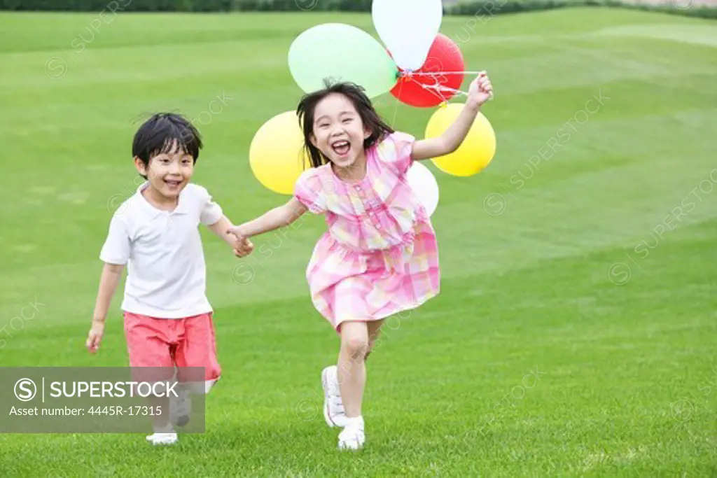 Happy children playing on the grass