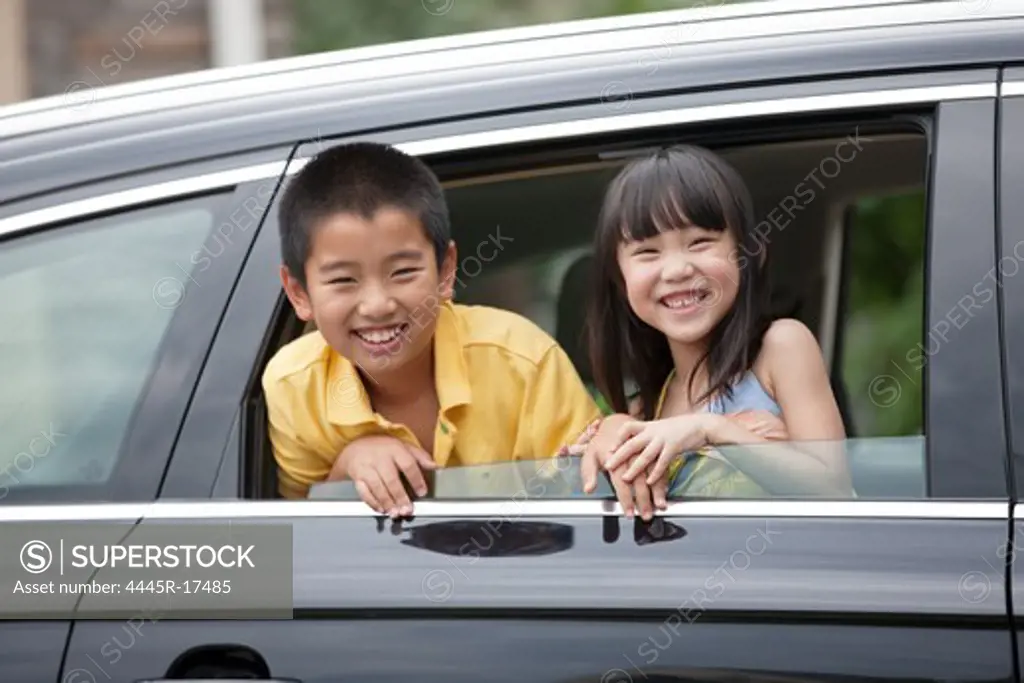 Happy children sitting in the car