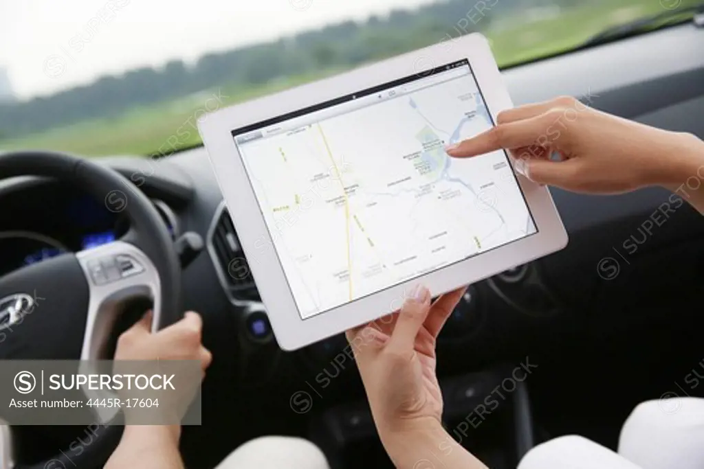 Young couple driving the use of navigation systems