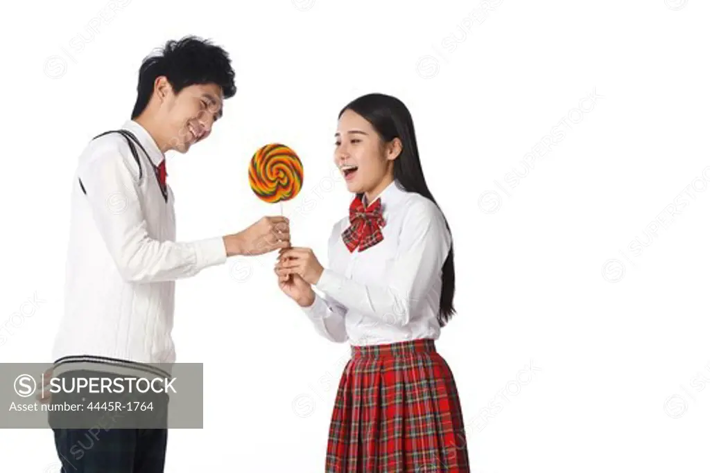 Student Young man and young woman with lollipop