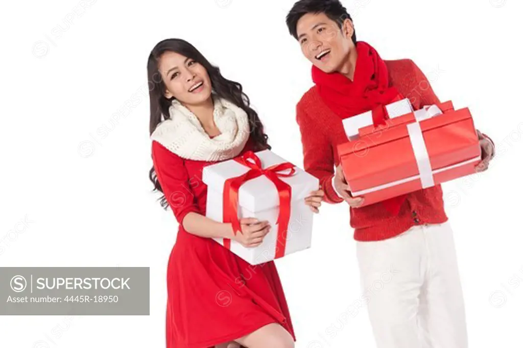 Young couple holding a Christmas gift