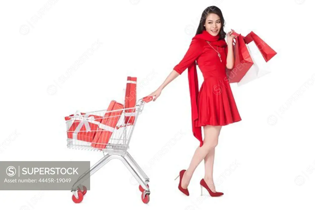 Young woman pushing a shopping cart