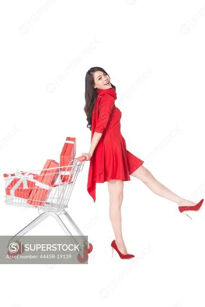 Young woman pushing a shopping cart