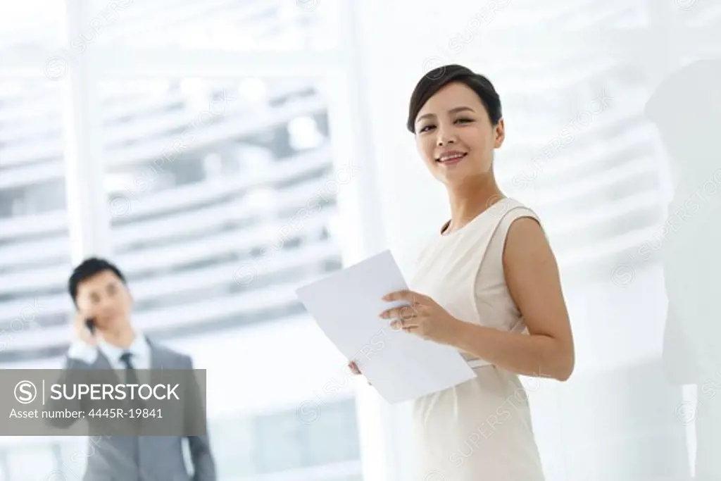 Young business woman holding documents