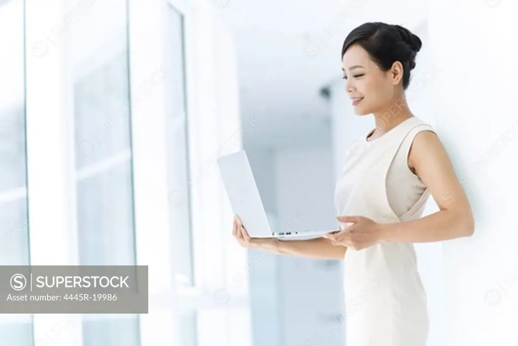 Young business woman using notebook phone