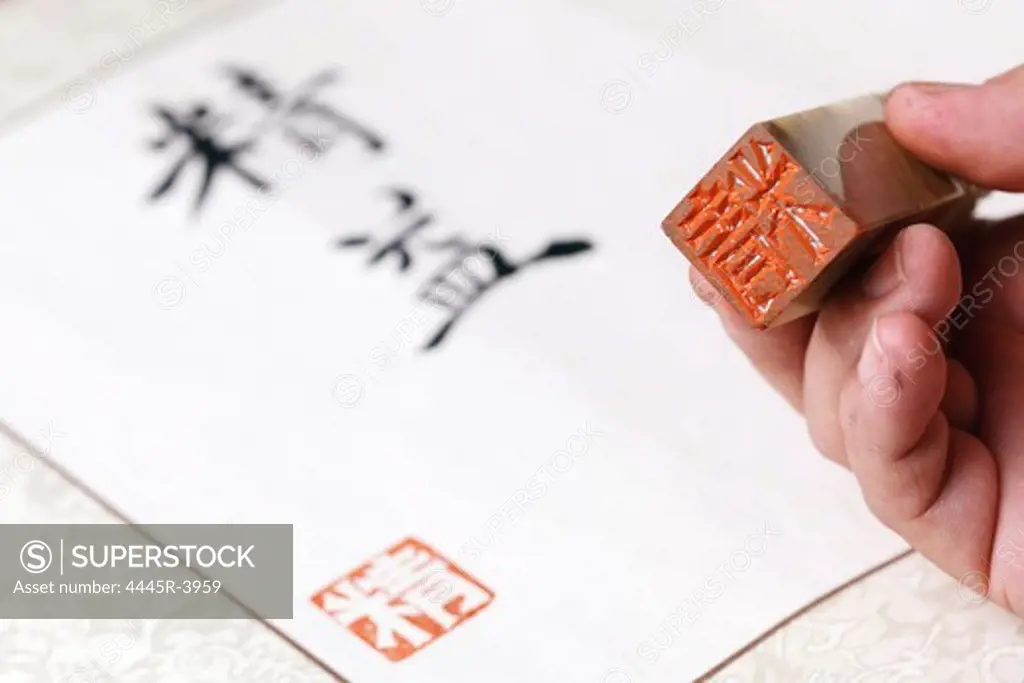 Calligrapher holding a stamp