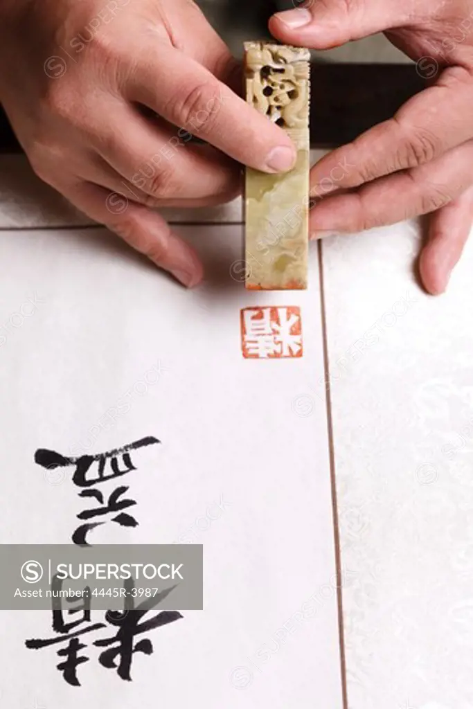 Calligrapher holding a stamp