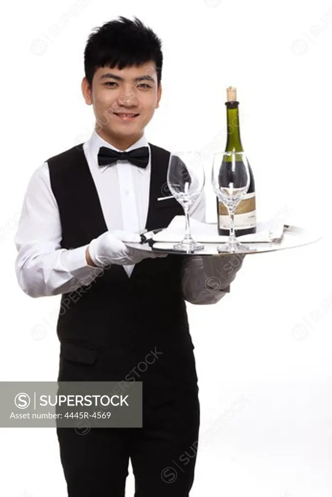 Waiter carrying wine bottle and glasses