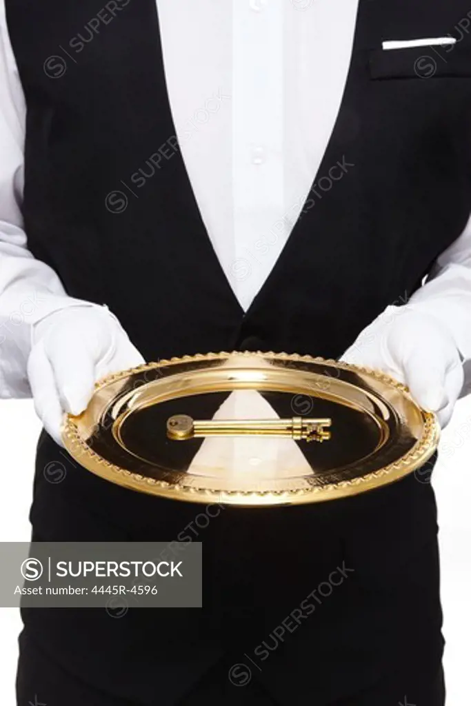 Waiter carrying key with gold tray