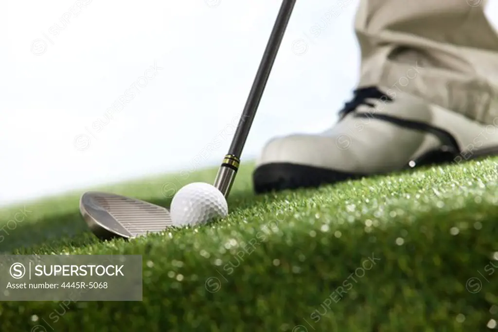 Golf player teeing up to hit ball