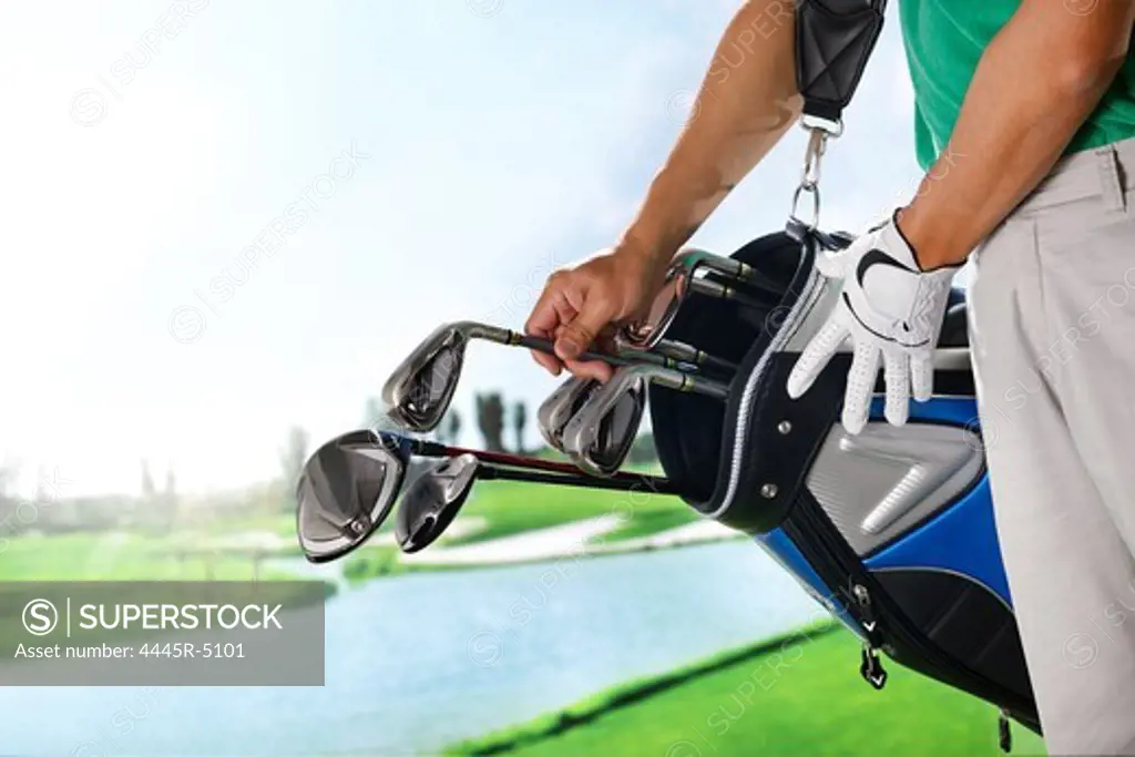 Golf player removing golf club from bag