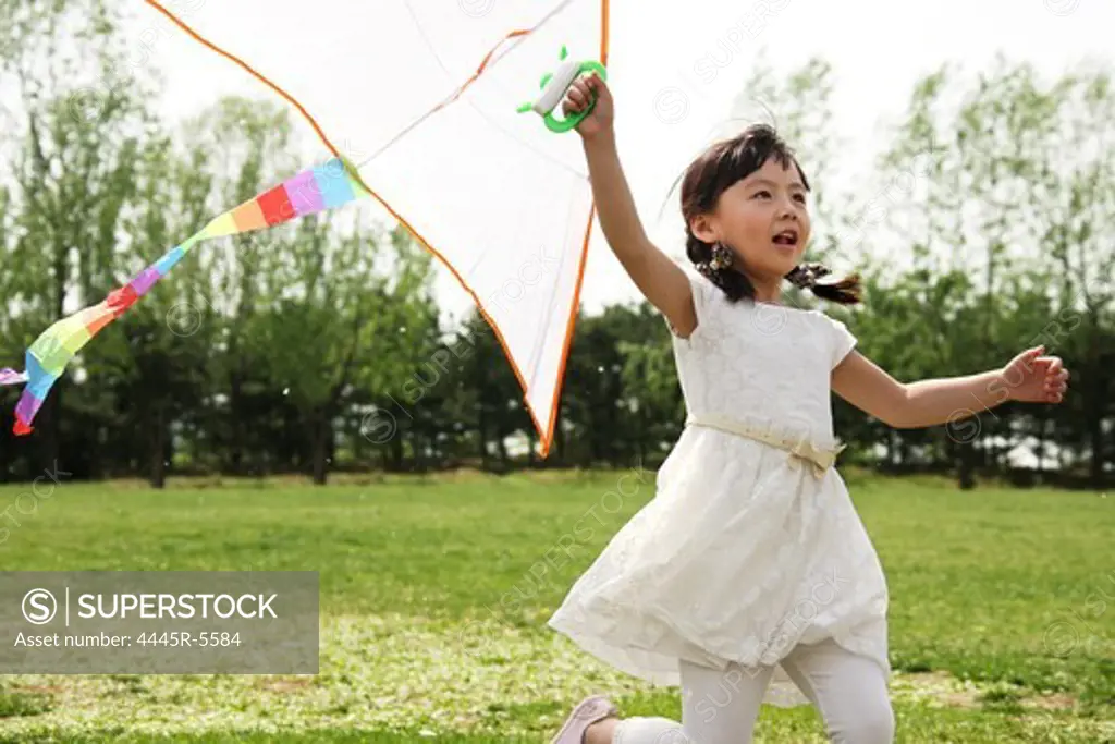 A girl playing kite outside