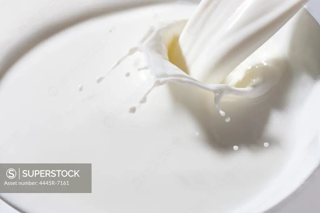 Milk pouring into a bowl
