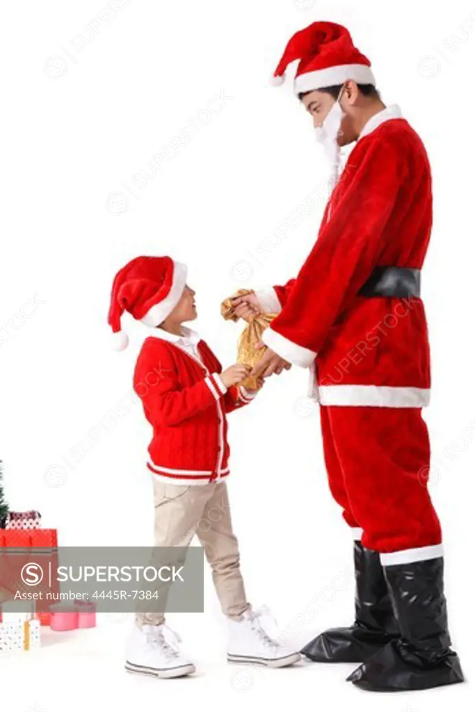 Boy with young man in Santa costume