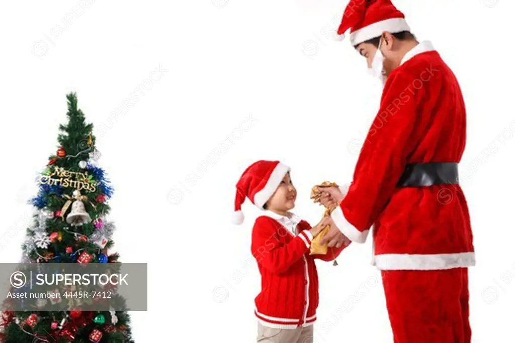 Boy with young man in Santa costume
