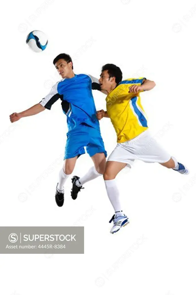 Two young men playing football