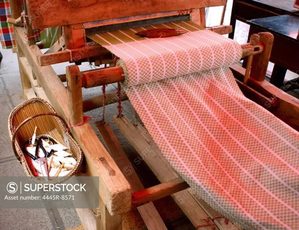 Weaving cloth on loom,close-up