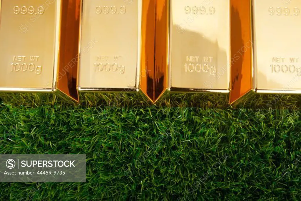 Bars of gold on grass