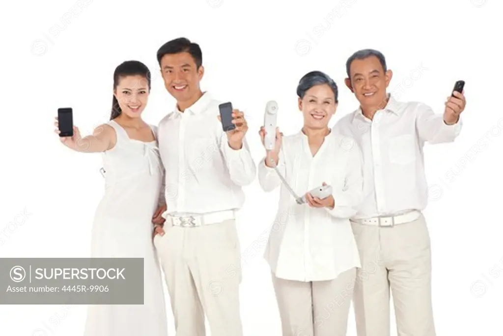 Whole family holding cell phone