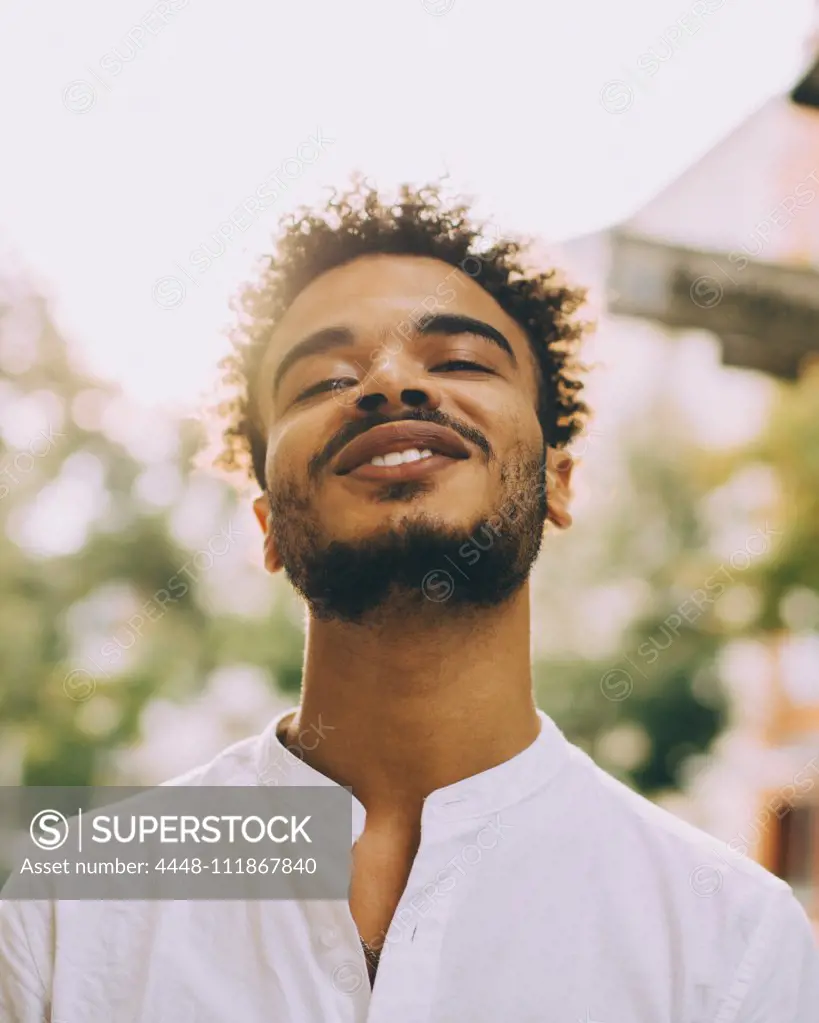 Portrait of smiling young man in casuals during sunny day