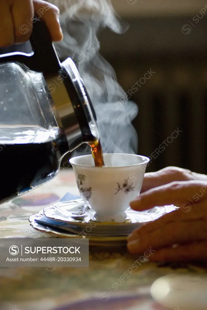 Pouring coffe in cup