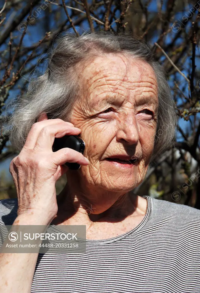 Old woman talking on the phone