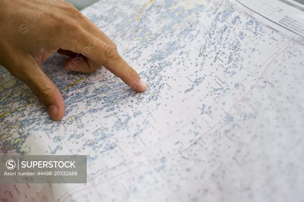 Hand pointing at map