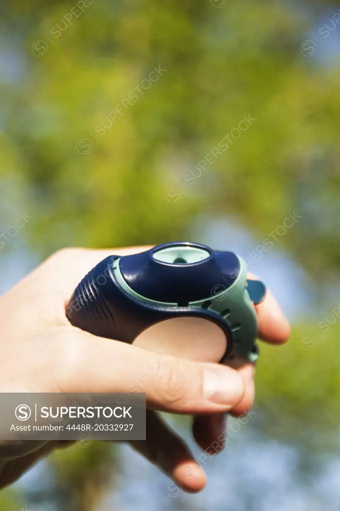 Hand holding asthmatic medicine