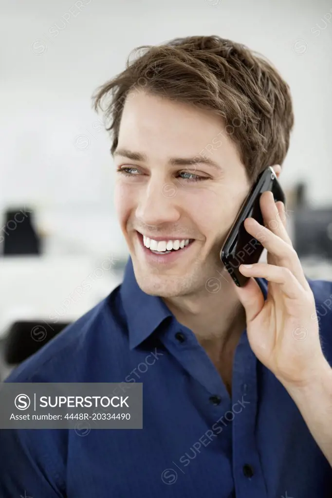 Smiling man talking in phone