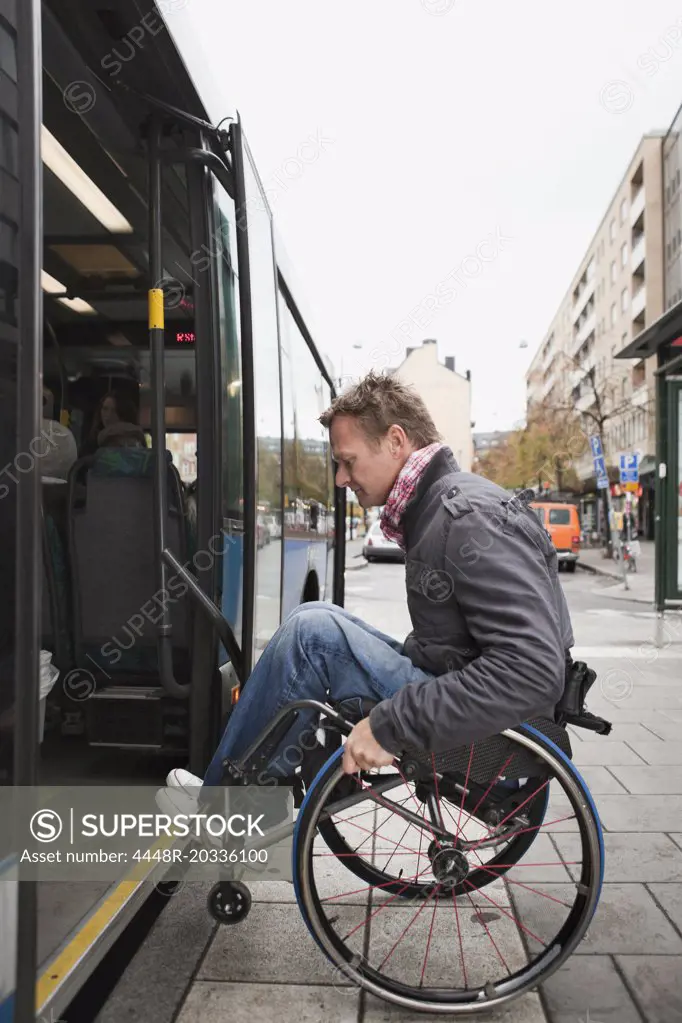 Man in wheelchair rolling on the bus