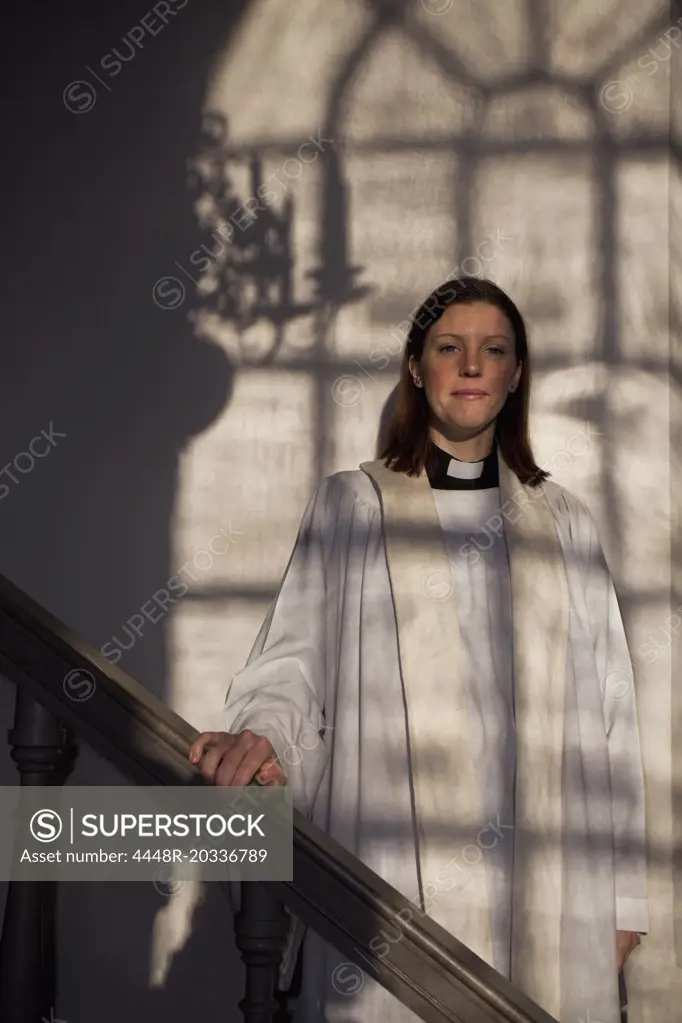 Priest in the light from window