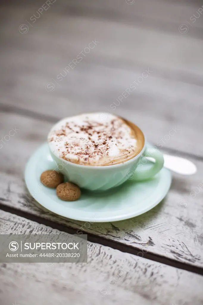 Sugar cubes beside cup of cappuccino