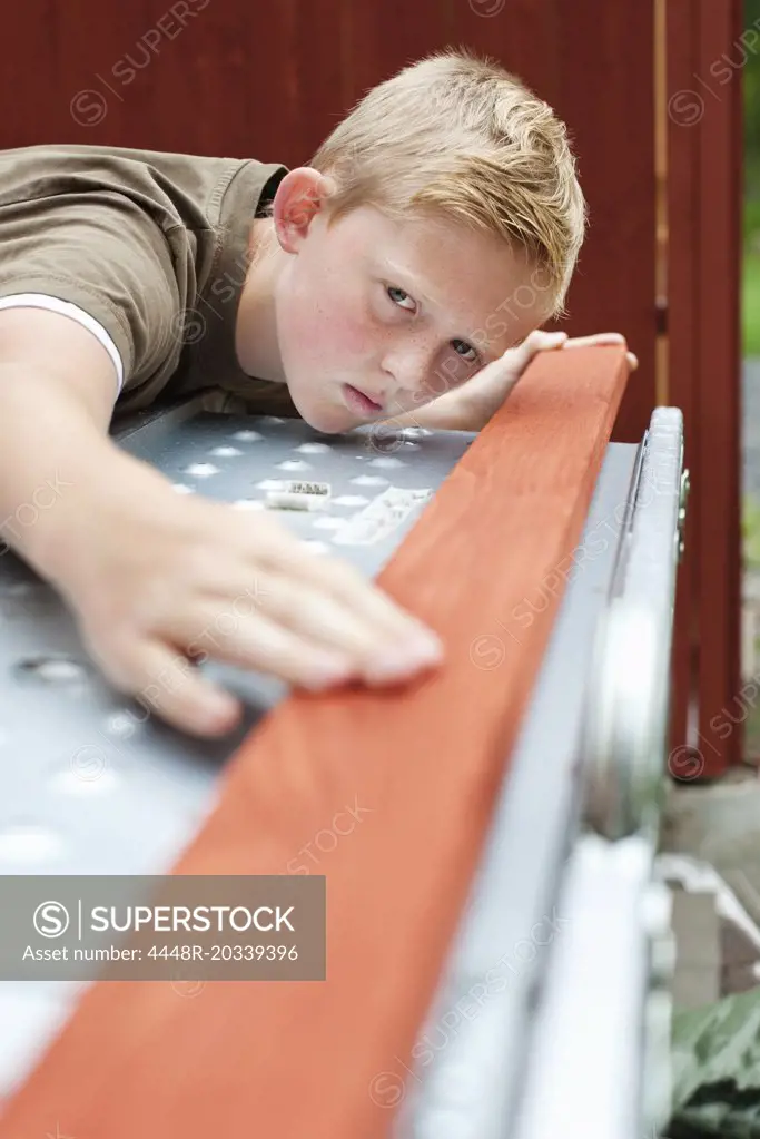 Pre-adolescent boy concentrating on carpentry