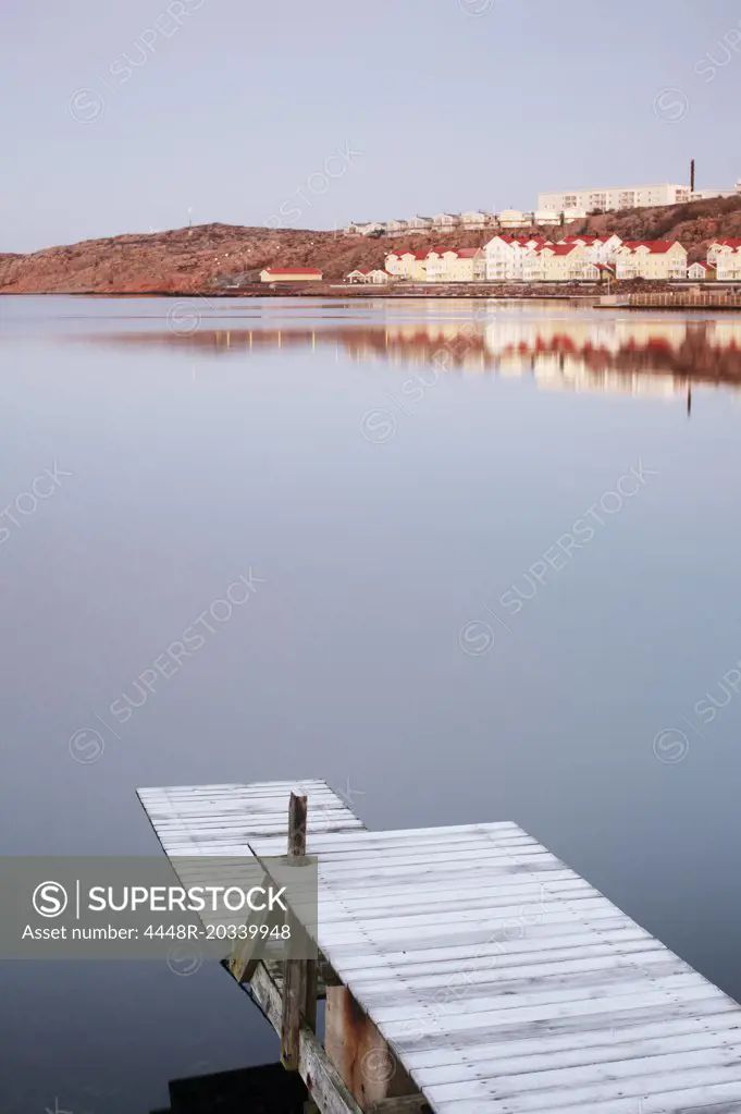 View of houses on side of lake reflecting on water